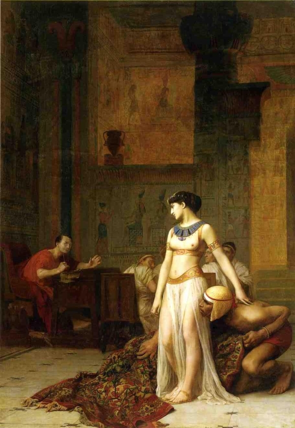 Cleopatra confronts Gaius Julius Caesar after emerging from a roll of carpet.