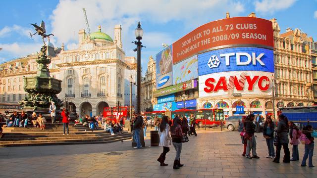 History Trivia Question: Which brand was the first to appear in neon lights in Piccadilly Circus, London?