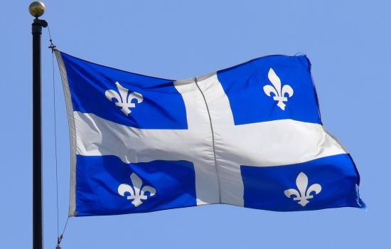 Geography Trivia Question: The flag of which Canadian province features four fleurs-de-lis flowers?