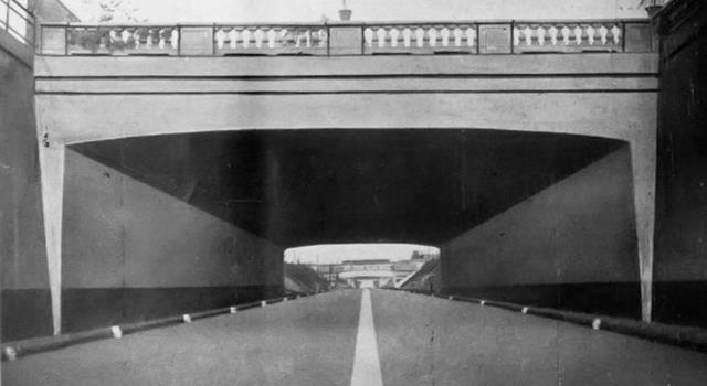History Trivia Question: In 1924 the world's first motorway opened which ran from where to where?