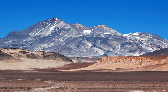Geography Trivia Question: Where is the highest active volcano in the world, Ojos del Salado, located?