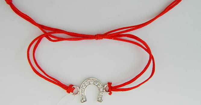 Culture Trivia Question: What does a thin scarlet string worn as a bracelet or band on the left wrist mean?