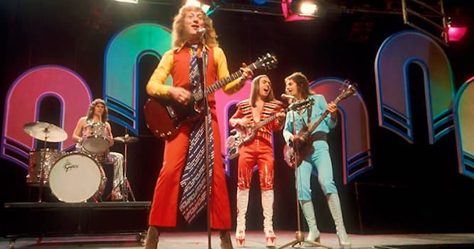 Society Trivia Question: Which Slade song did drummer Don Powell have to be lifted into onto his drum-kit after his 1973 car crash?