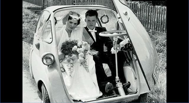 Culture Trivia Question: The photo is of German newlyweds in 1955. Name the manufacturer of their "limo".